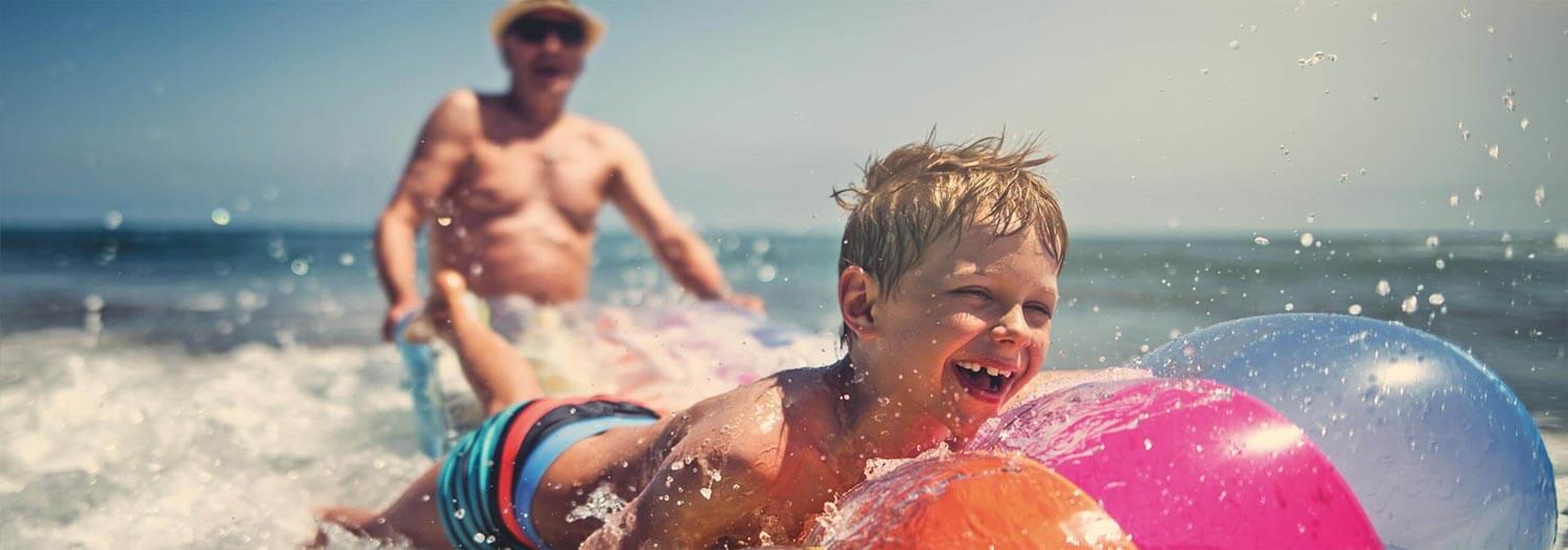 A grandfather and his grandson at the beach