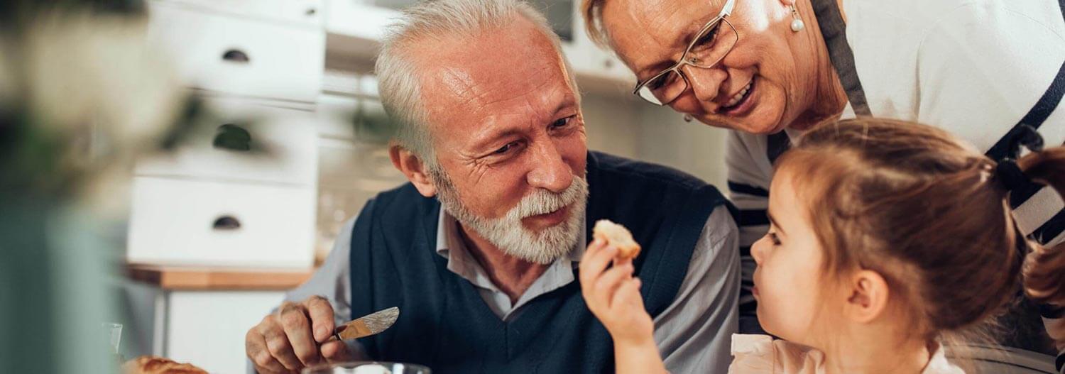 Grandparents having breakfast with their grandchildren